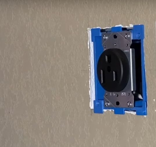 blue 3-prong uncover outlet on the wall