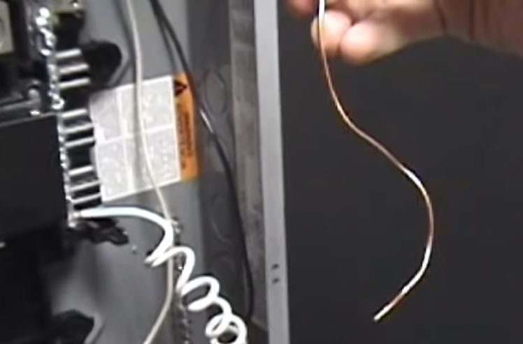 A person connecting the neutral pigtail wire to the neutral bar
