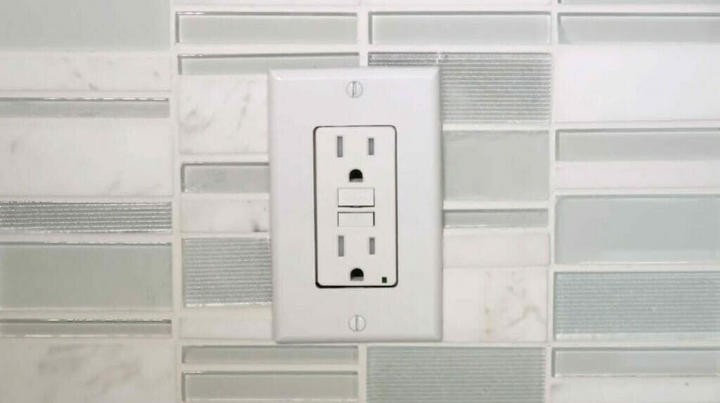 GFCI outlet installed on a tiled wall