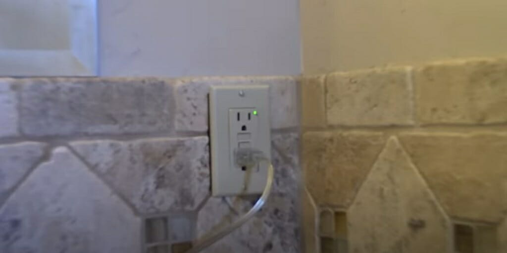 GFCI outlet mounted on a marble tile