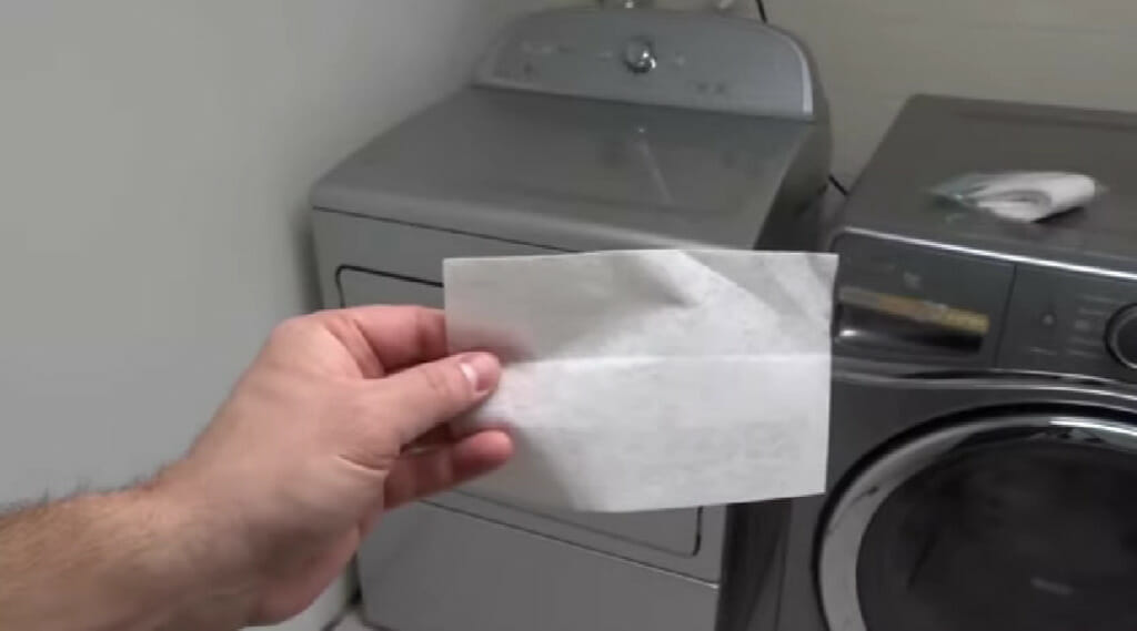 hand holding a dryer sheet