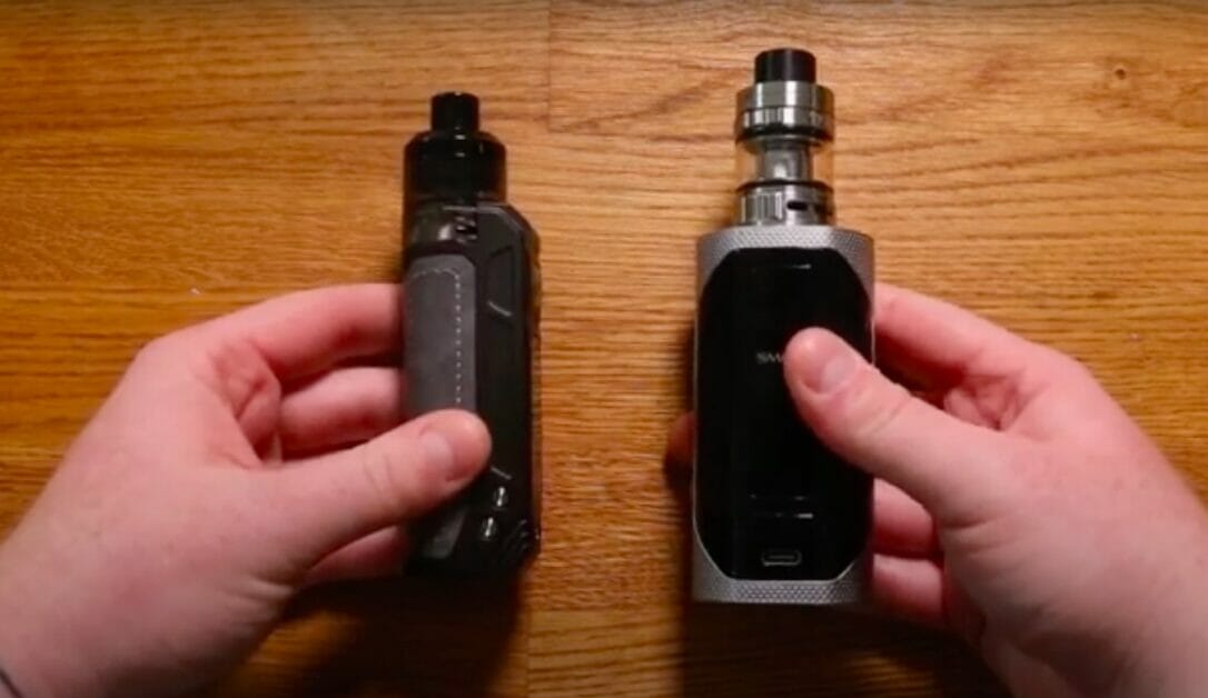 hands holding a vape and its battery cart