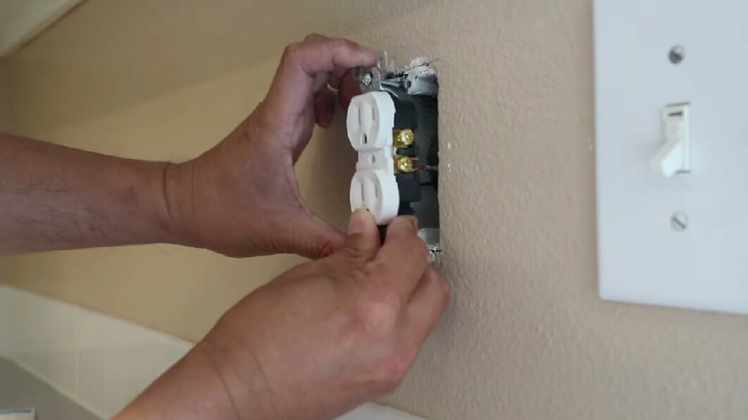 man installing a new outlet on the wall