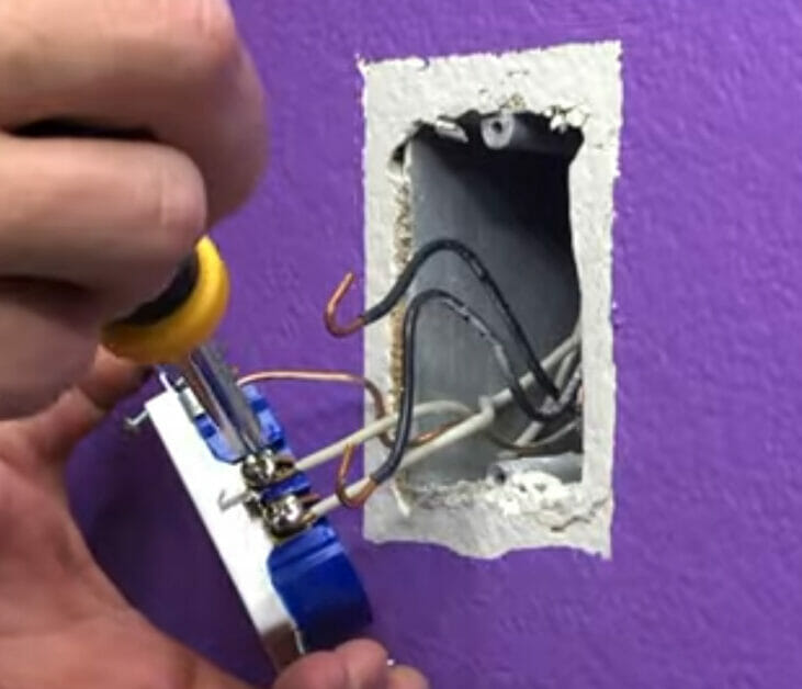 man removing the outlet using screwdriver