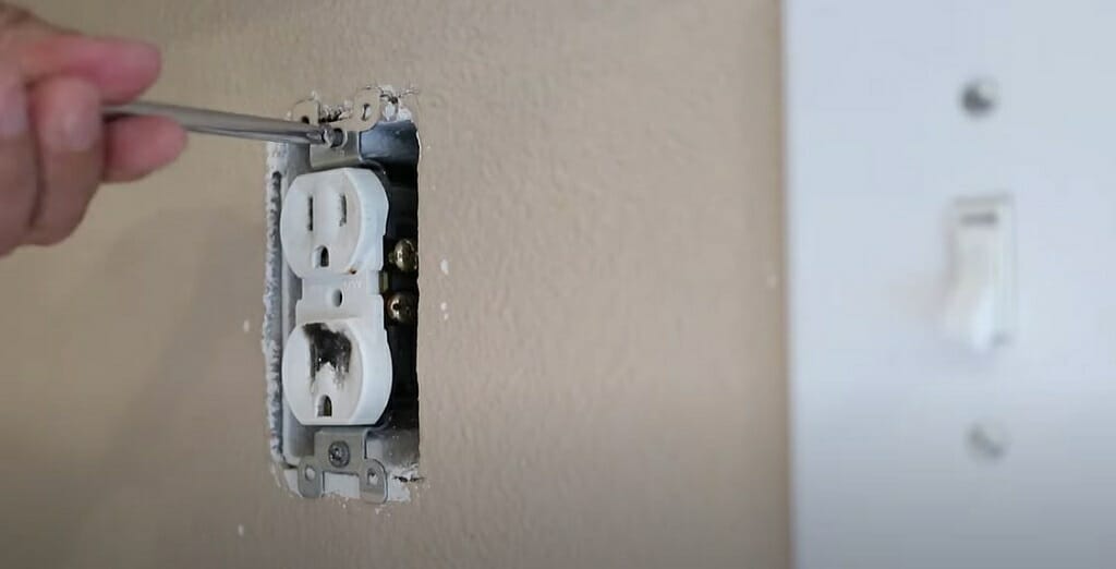 man screwing an outlet