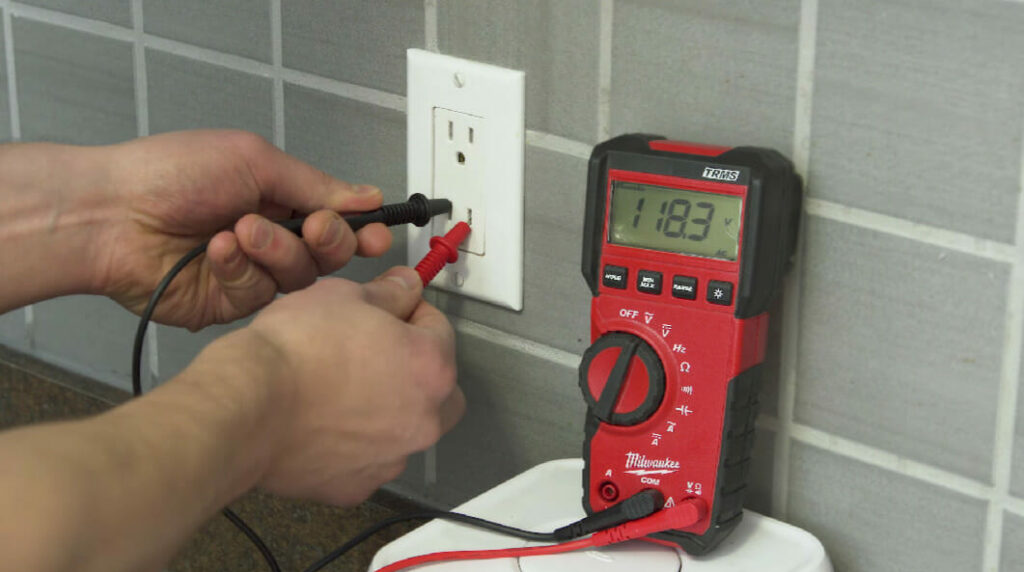 man testing the outlet with a multimeter