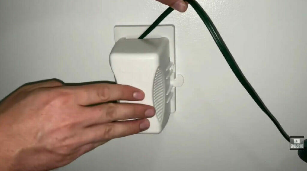 man's hand putting cover on the outlet holes