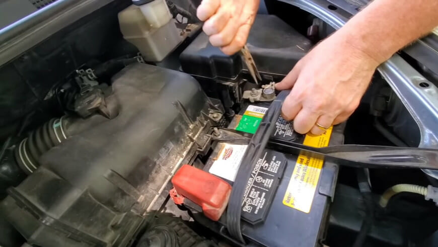 mechanic working on car battery