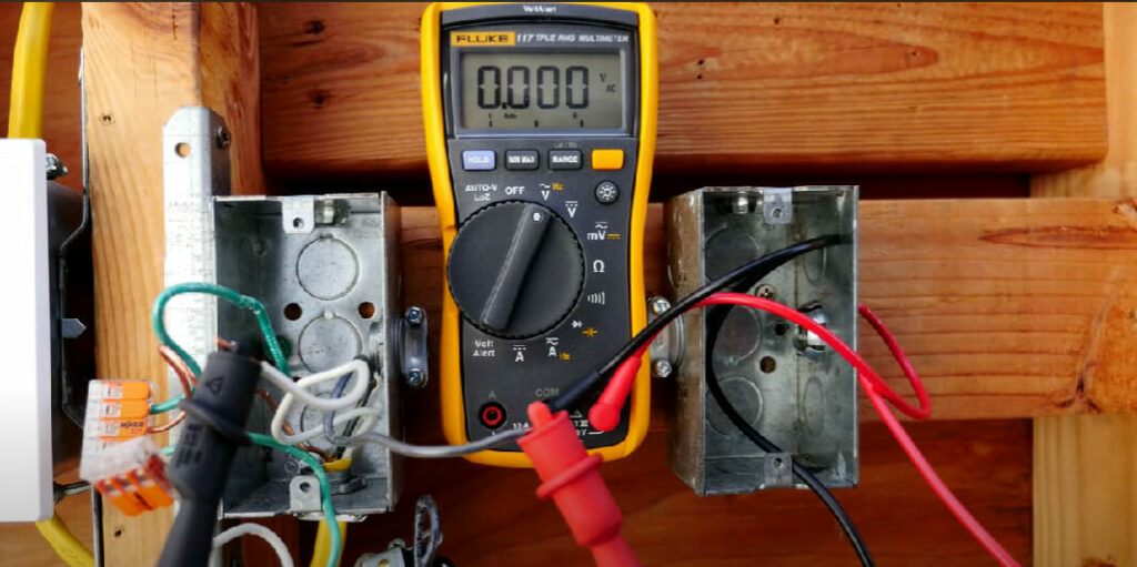 multimeter test to a two electrical boxes