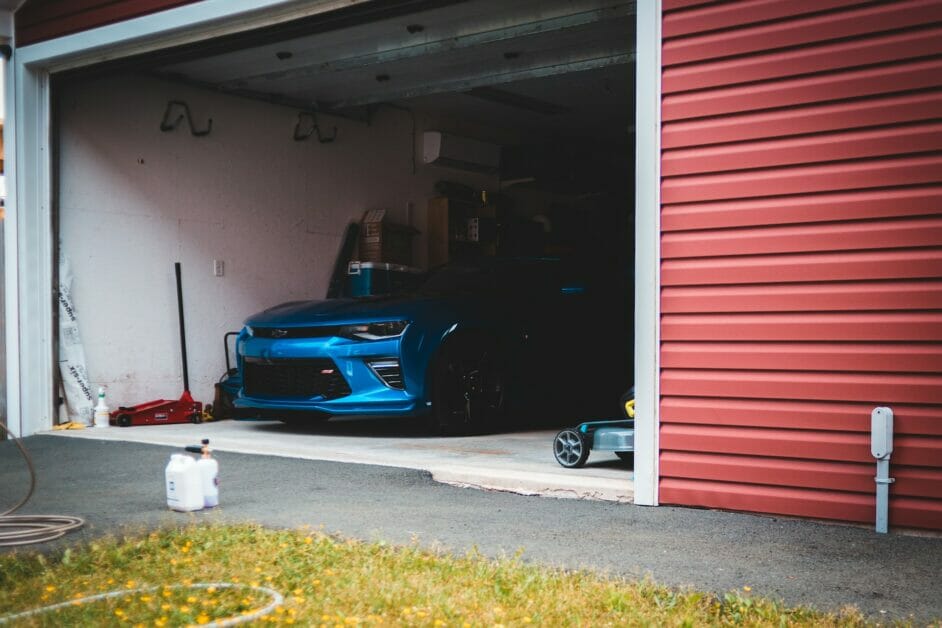 open garage with blue car inside