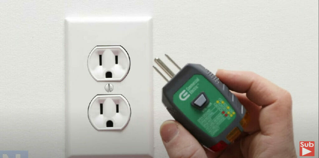 outlet and a hand holding a plug