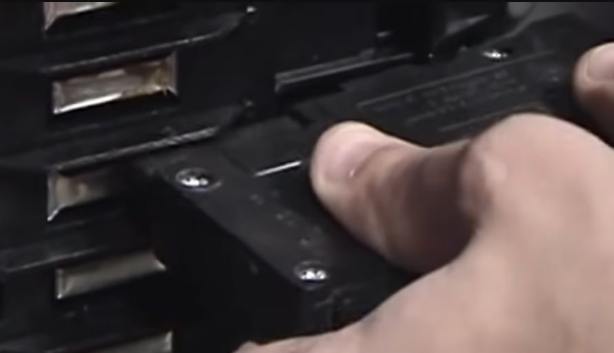 A person setting the breaker into the panel