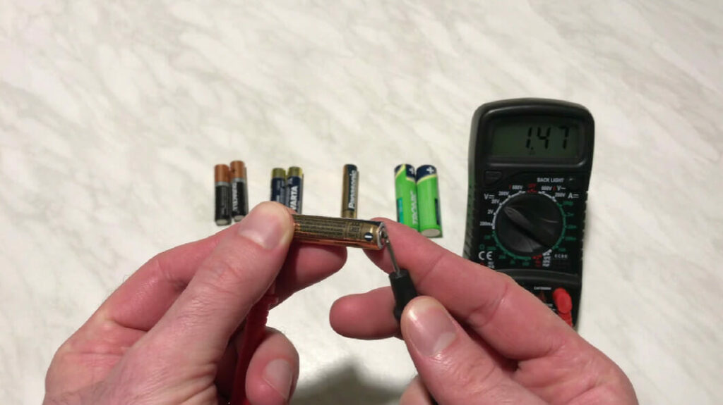 testing one end of an aaa battery with a multimeter