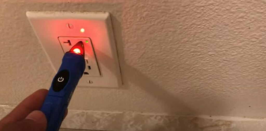 testing the wall outlet with non-contact voltage tester
