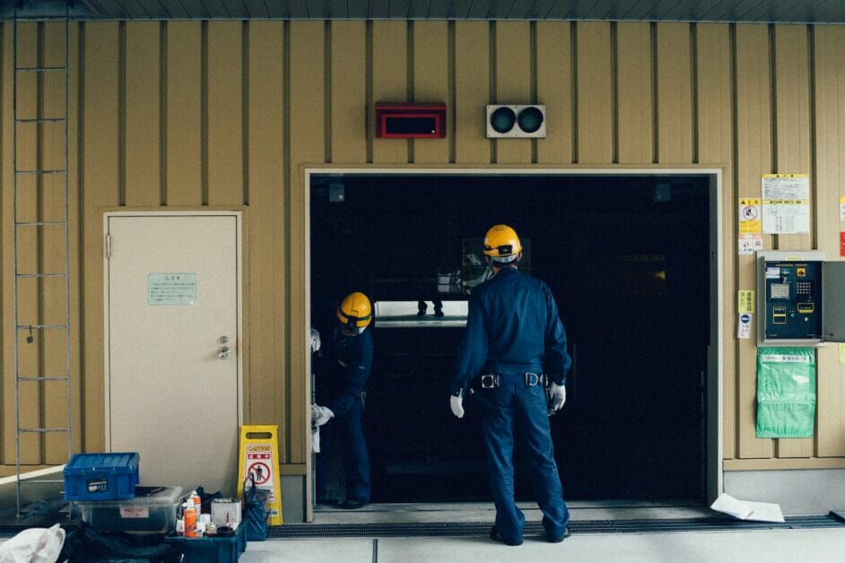 two men working on the garage door