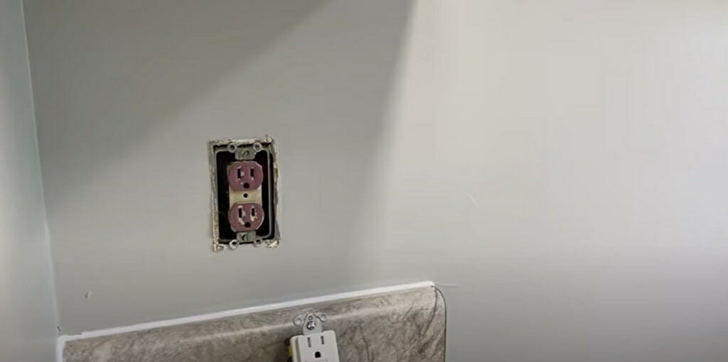 undone and uncovered outlet on the wall