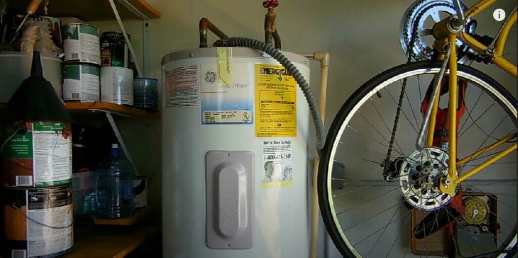 water heater besides a bike and tin containers