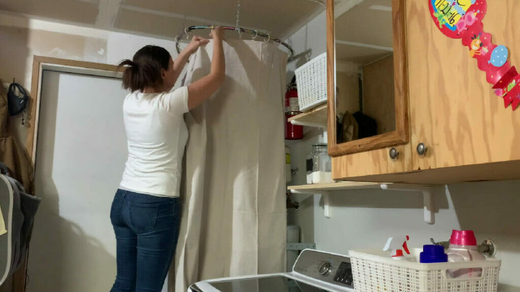 woman putting up round curtains