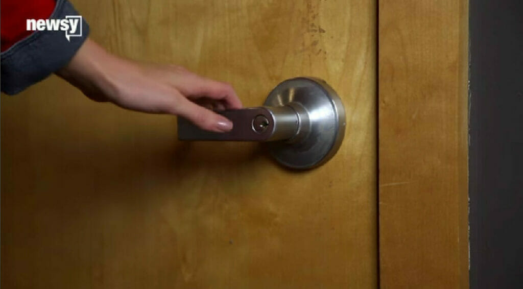 woman's hand holding the door knob