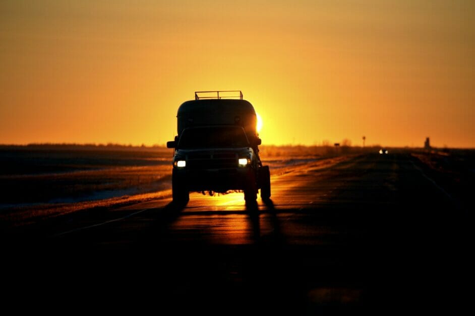a beautiful sunset backdrop of a running vehicle