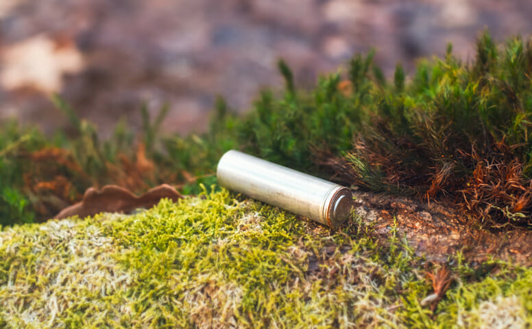 a corroded battery on the grass