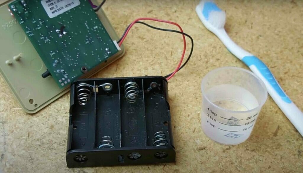 cleaning battery cartridge using solution and toothbrush
