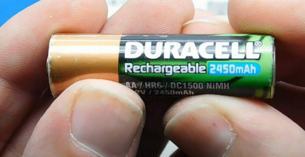 hand holding a duracell AA rechargeable 2450mAh battery