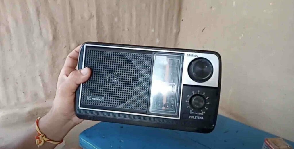 left hand holding a portable radio