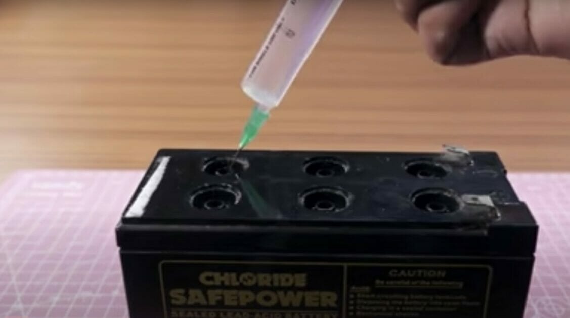 putting water on a battery using syringe