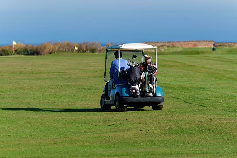 a golf cart with people on the golf field