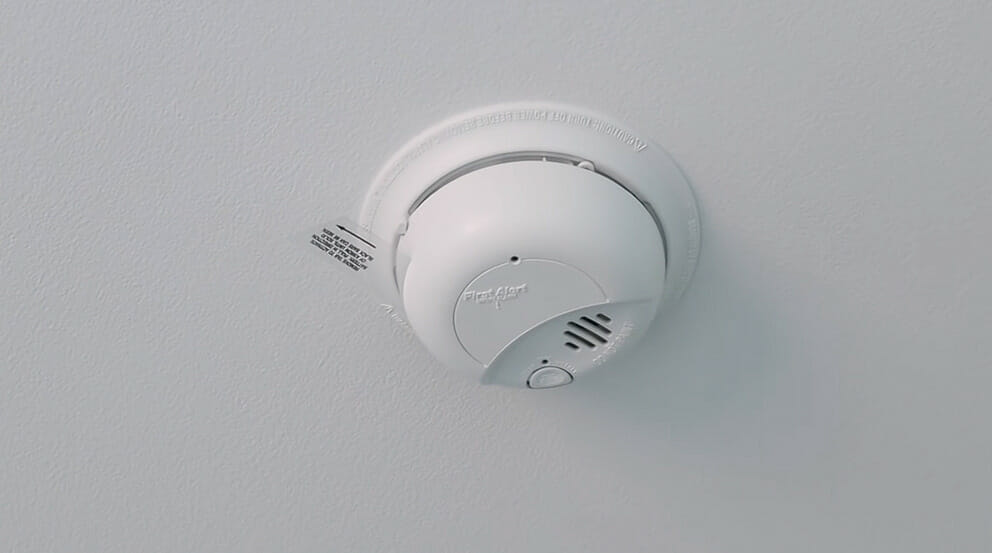 a hard-wired smoke detector mounted at the ceiling