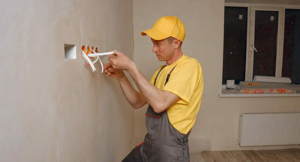 an electrician hardwiring an outlets