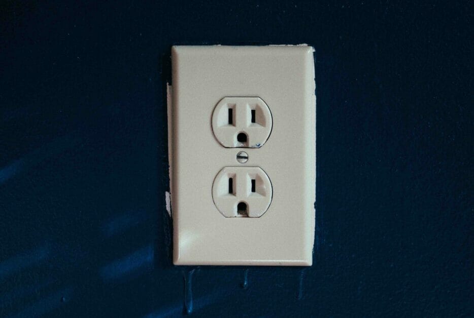 an outlet in a dark blue wall