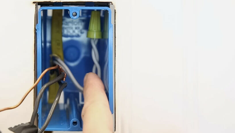 capping off wires on a blue electrical box