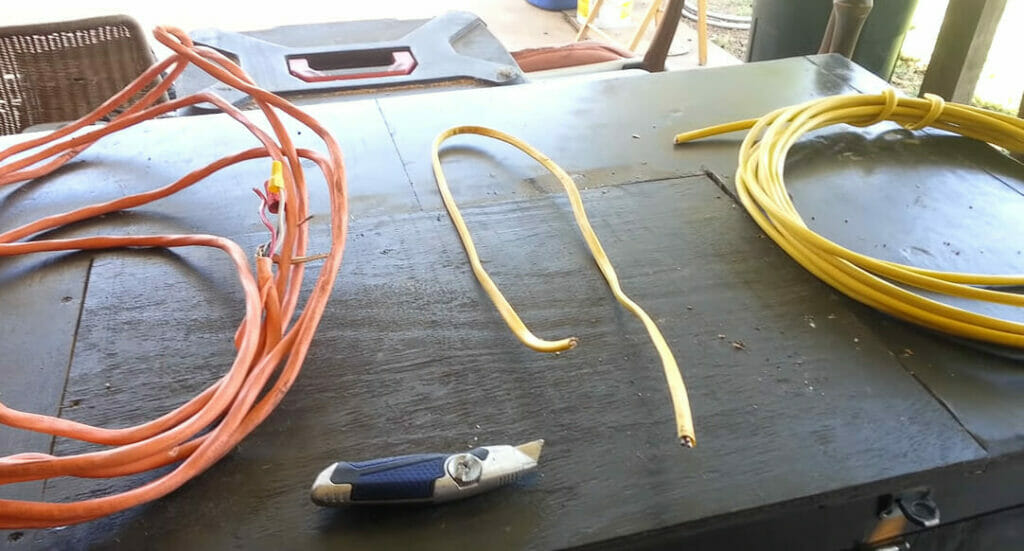 orange and yellow romex wires on the table