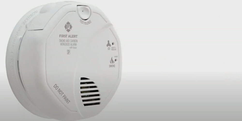 A hard-wired smoke detector on a white background