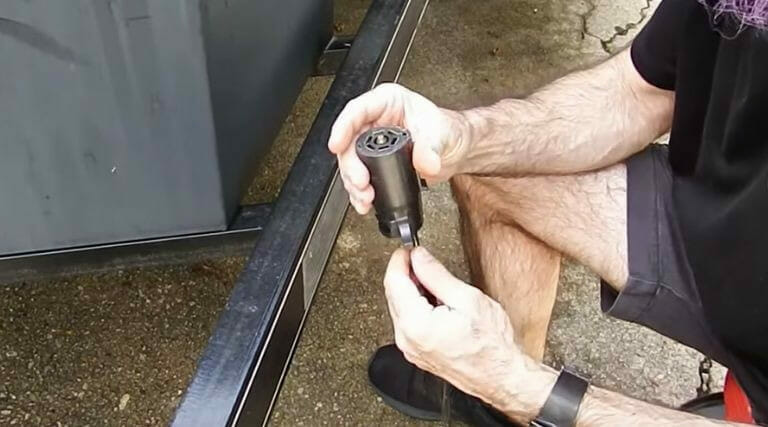 A man is using a screwdriver to tighten a bolt