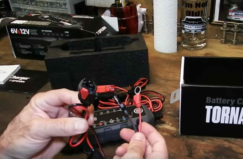 A person is putting a battery on a table