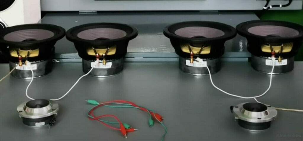 four speakers with wires on the table