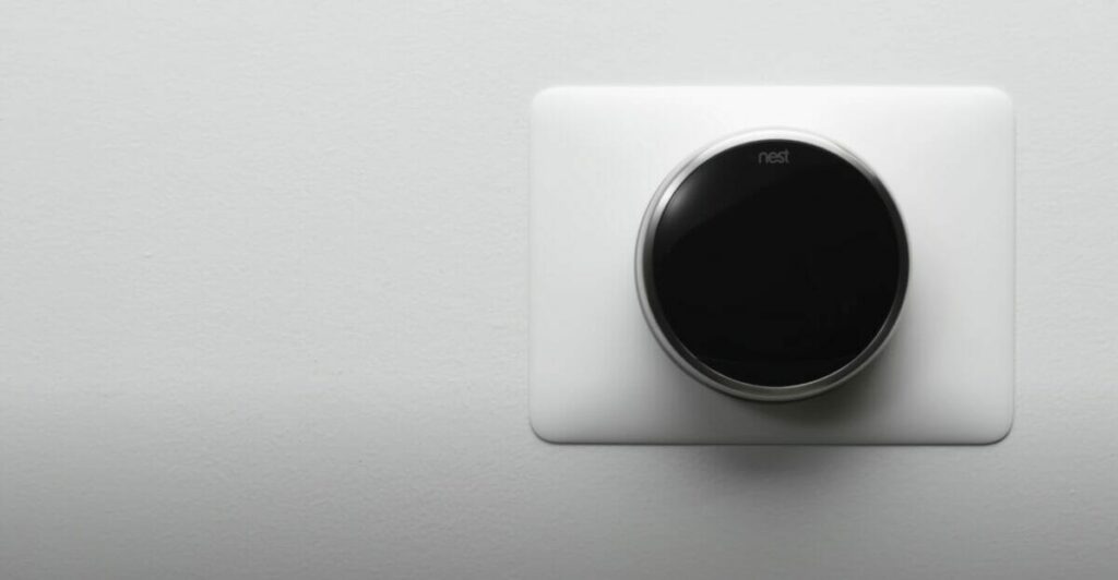 google nest thermostat on a white wall