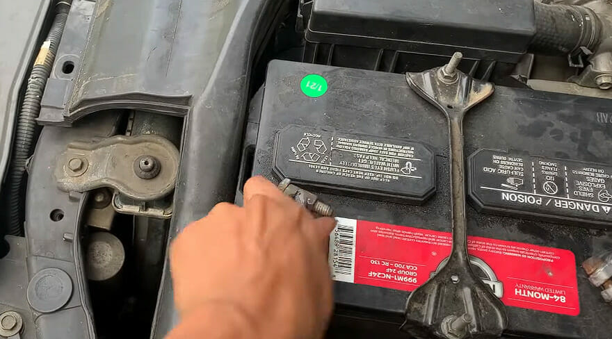 A person disconnecting a battery