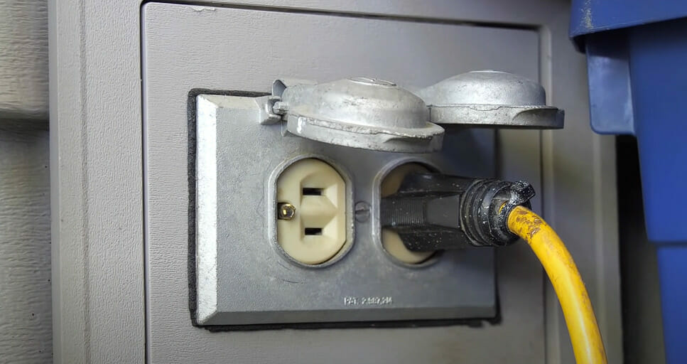 A RV plug with wire plugged in it