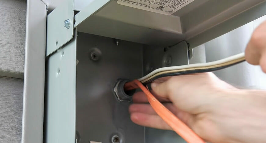 A person is wiring a metal box for an RV plug with 30 amps