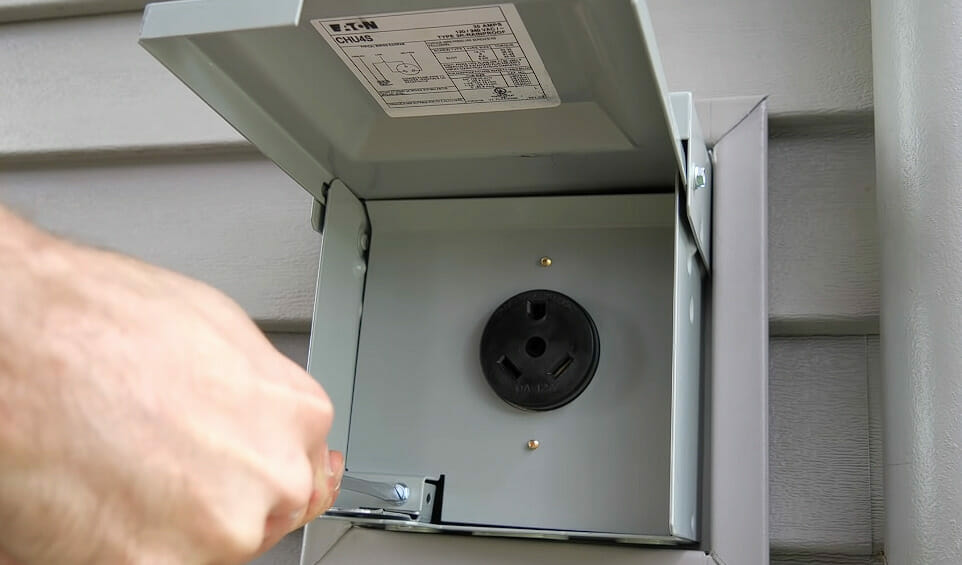 A person is attaching the receptacle cover of an RV plug