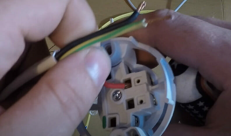 A person connecting wires to the switch