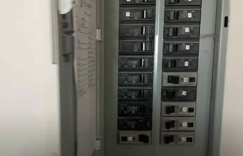 A zoom image of an open electrical main panel mounted on wall