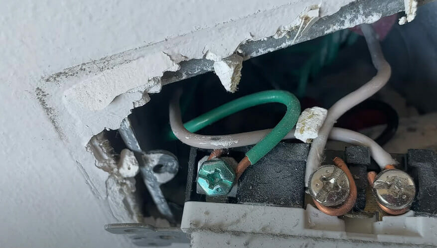 A broken light switch with wires in it, needing a quick and easy fix for a hot ground wire
