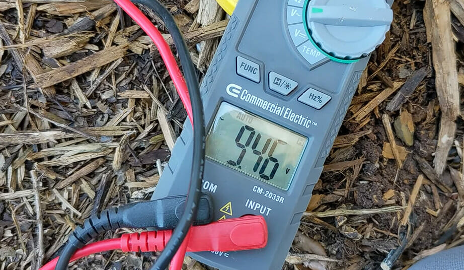 A digital multimeter is laying on the ground