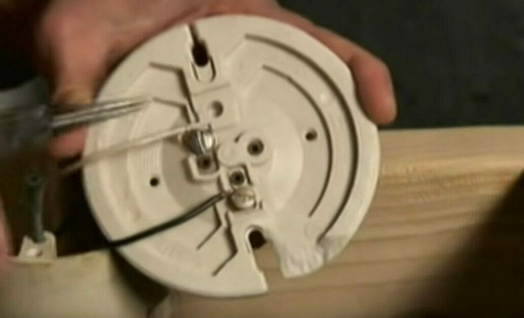 a man connecting white and black wire into an electric socket