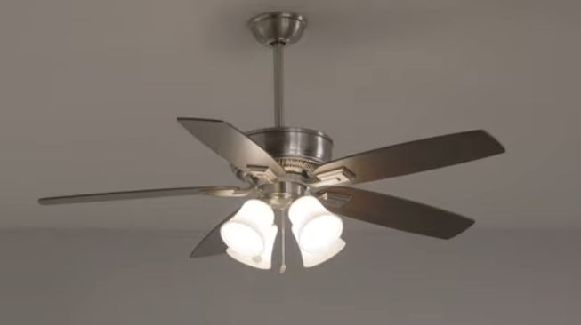 A ceiling fan with four blades in a room